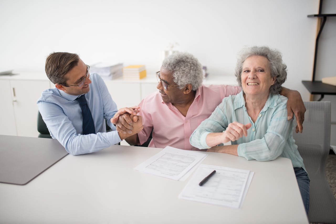 Crafting Captivating Headlines: Your awesome post title goes here Senior couple in office meeting with consultant, discussing financial documents and smiling.